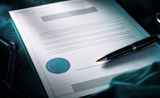 Close-up of a written settlement agreement letter on hospital letterhead with a signature line
