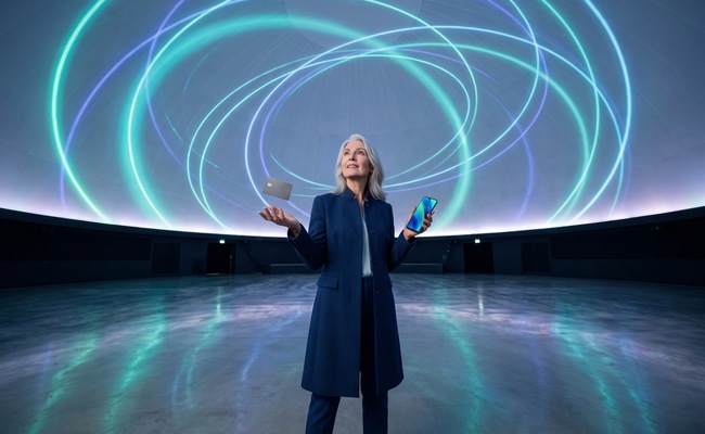A person considers how a lower credit card limit can change utilization beneath abstract planetarium light.