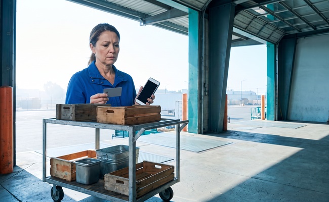 A person adult person weighs available credit before deciding whether to close a credit card after payoff beside a public-market loading dock.