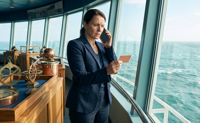 A person adult person calls an issuer about fees before deciding whether to close a credit card after payoff in a maritime museum gallery.