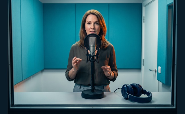 A person adult person rehearses a calm three-part issuer request in a radio booth before she tries to negotiate credit card annual fee.