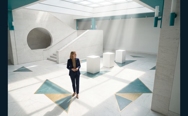 A person adult person considers three illuminated choices in a museum atrium after asking whether she can negotiate credit card annual fee.