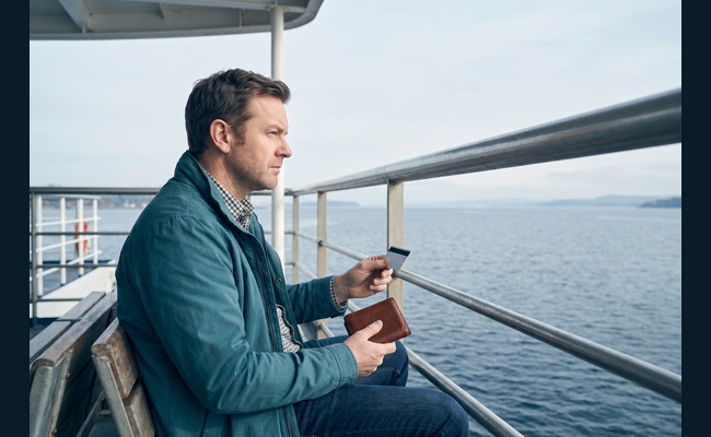 A person adult person weighs three account paths on a bright commuter ferry while deciding whether to negotiate credit card annual fee.