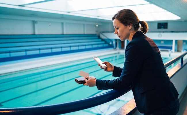 A person adult person weighs emergency cash and the choice to pay off personal loan early from an aquatic-center balcony.