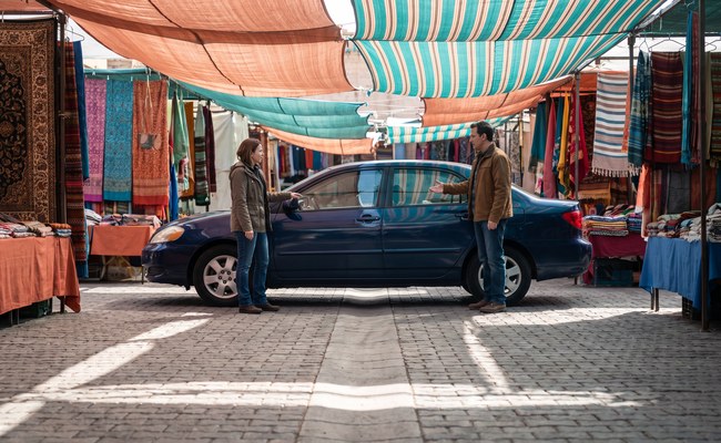 A person adult reviews the next comparison step while considering voluntary repossession vs selling car.