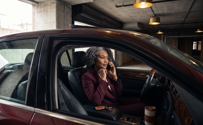 A person borrower making a safe lender call after a car loan kill switch warning