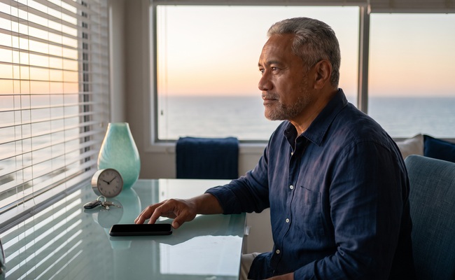 A person homeowner weighs next steps in a coastal home office.