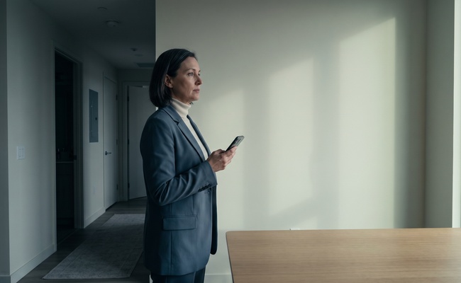 A person maps recurring payment dates and deposit timing beside an unmarked blank wall.