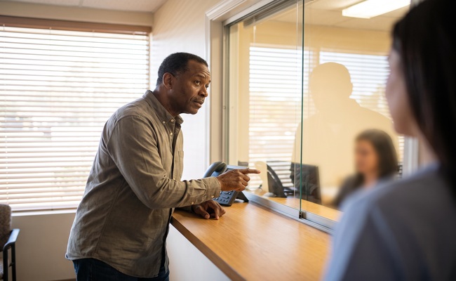 A person adult patient confirms which provider and account a medical bill belongs to before paying.