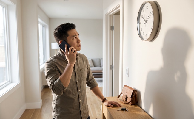 An adult checks the time and gathers facts before responding to an urgent housing or utility threat.