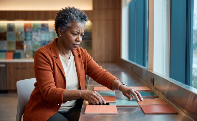 Person organizing payment dates at a community lounge counter.
