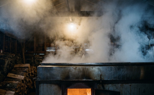 Steam rising from a sugar shack evaporator, showing time passing the way a post judgment discovery request deadline runs from the day of service.