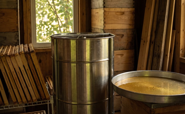 Stacked unpainted hive boxes and an extractor drum in an apiary honey house, the sorting of like from unlike that identifying a ground to challenge an incorrect judgment requires.