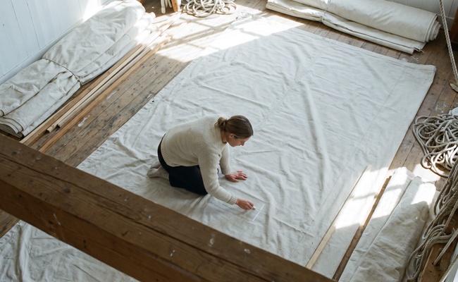 Sail maker marking a single line on spread canvas, the record keeping that credit freeze vs fraud alert protection depends on