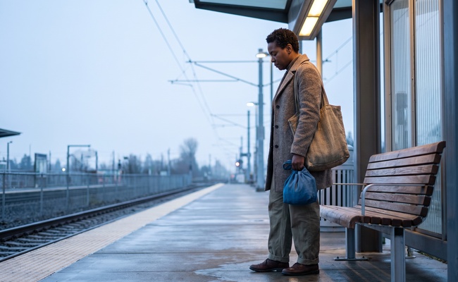 An adult carries a reusable tote while considering the next household cash-flow step.